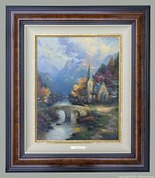 Full front view of framed painting showing "Mountain Chapel" by Thomas Kinkade with official framing.