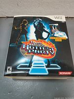 Boxed Dance Dance Revolution Hottest Party game cover for Wii, showing the main game controller inside