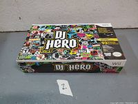 Closed box of DJ Hero for Nintendo Wii with colorful sticker-style design on cover