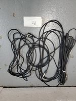 Lot of mixed 1/4 inch cables laid out on floor including extension, RCA adapter, and speaker cable.