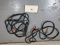 Two coiled black stereo 1/4 inch to RCA cables on the floor for general overview.