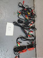 Pile of various RCA cables with different colored connectors on floor.