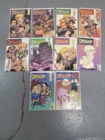Photo showing 10 comic books from Drakuun series by Johji Manabe arranged in two rows on a floor, with colorful covers featuring fantasy characters. All comics appear bagged and boarded.