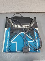 Folded Dance Dance Revolution dance mat showing directional arrows and cable