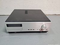 Front view of the Antec Fusion silver ATX case showing Blu-Ray drive slot, volume knob, power button, and multiple USB and audio ports.