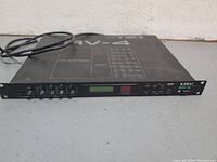 Front view of Kawai RV-4 effects processor with power cord attached, showing control knobs, display, and buttons.