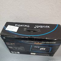 Box of Qanba Fighting Joystick showing the top with logo and product name.