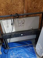 Side view of Seal Masterpiece 500T dry mount press with power cord and sturdy metal frame.