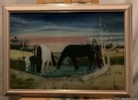 Framed original artwork depicting two horses drinking water from a pond with natural landscape background and sunset sky.