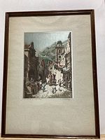 Framed art print titled 'Visit of the Sovereign' by Carl Spitzweg showing a historical street scene with multiple figures and a clock tower, mounted under glass in a wood frame with a cream mat.