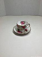 Front angled photo of the Queen Anne Lady Sylvia teacup and saucer showing floral design and gold trimming