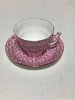 Photo of Sampson Smith Old Royal bone china teacup and saucer in pink and aqua floral chinz pattern with gold rims.