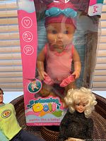 Photo of Swimming Doll in original packaging with pink design and goggles on head
