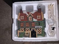 Ceramic Dedlock Arms building from Dept 56 with attached power cord, in original white styrofoam packaging