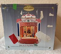Original box showing the front view of the musical nutcracker Christmas decoration with visible wear and old stickers.