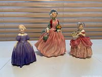 Front view of all three Royal Doulton ceramic dolls on display