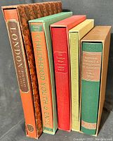 Five Folio Society hardcover books with original slipcases, standing upright to show spines, in excellent condition.