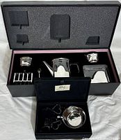 Full view of boxed silverplate tea set including teapot, cream jug, sugar bowl, teaspoon, toast rack, and tray, showing foam insert for protection