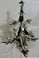 Front and side view of the shiny chrome Christmas tree candle holder showing star top and multiple candle bulb holders on tree branches