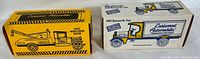 Photo showing original packaging boxes for two ERTL toy coin banks: 1933 Wrecker Bank and 1925 Kenworth Van Bank.
