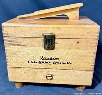 Front view of wooden rectangular box with metal latch and printed logo