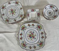 Group top view of eight square plates, two bowls, square trinket dish and handled cookie platter