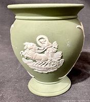 Sage green jasperware vase showing detailed raised white cameo scene of a chariot with a winged horse and goddess figure.