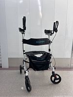 Front view of the Elenker rolling walker showing padded armrests, handbrake levers, frame, and storage pouch.