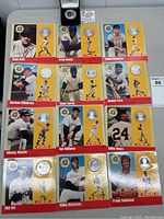 Overview of 12 Hall of Fame player coin display cards and one boxed Tom Seaver coin