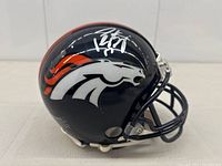 Side view of navy Broncos mini helmet showing Peyton Manning silver autograph