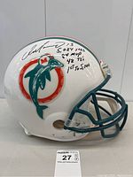 Front right quarter view showing signature, inscriptions and Dolphins logo