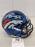 Front left view of metallic blue Denver Broncos mini helmet with white horse head logo and Von Miller silver signature across top
