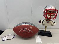 Overview of entire lot showing football, bust, authentication card