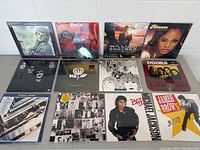 Overhead shot of twelve vinyl LP albums on table