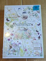 Front view of unopened puzzle box showing 'Summer' botanical themed 1000+ piece Cobble Hill puzzle