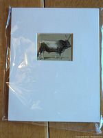 Front view of lithograph mounted on white mat board, showing detailed bovine figure.