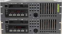 Front view of two Tascam DA-78HR digital audio tape machines stacked, showing control panel, buttons, sliders, and digital displays.