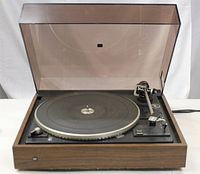 Clear view of Dual Model 510 turntable with dust cover open showing platter, tonearm, and control panel.