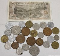 28 pieces of foreign currency including coins and one 20 Schilling banknote showing a mountainous landscape.