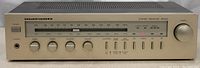 Front view of Marantz SR225 showing tuner dial, control knobs, and indicator lights, powered on.