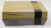 Front view of the Nintendo NES Model 001 console showing power and reset buttons, controller ports, and Nintendo Entertainment System logo.