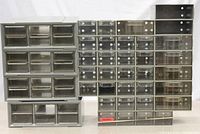 Front view of all five plastic storage drawer units showing clear drawers with some dividers and missing drawers.