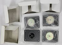 All four tweeters shown with their original packaging, some sealed in plastic and empty boxes behind.