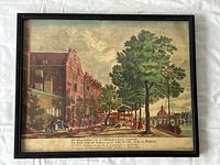 Full view of framed antique print showing an Amsterdam street scene with buildings, people, and trees.