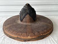 Front profile of the antique Salakot hat showing intricate bamboo weaving and black leather/fabric top details