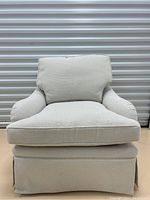 Front view of beige and cream check upholstered lounge chair.