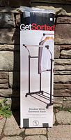 Full view of the original box showing the product image and branding 'Get Sorted Double Wide Garment Rack'.