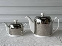 Pair of teapots side by side showing relative sizes and overall design