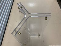 X-shaped lucite base viewed from above, connectors visible