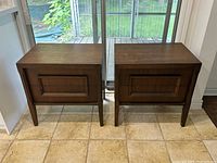 Front view of both tables showing matching design and drawer fronts
